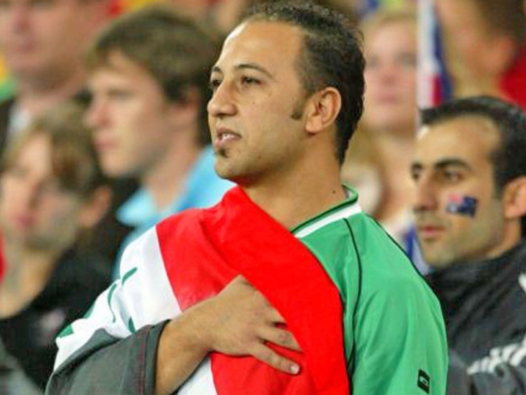 An Iraqi supporter holds his hand on his heart as his home countries anthem is played
