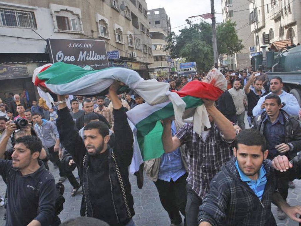 The funeral of members of the Daloo family in Gaza City yesterday; 11 members of the family were killed on Sunday in an Israeli missile attack on their house