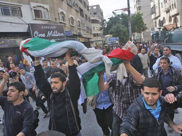 The funeral of members of the Daloo family in Gaza City yesterday; 11 members of the family were killed on Sunday in an Israeli missile attack on their house