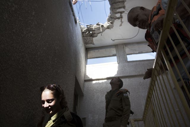 Israelis inspect damage caused by a Palestinian missile