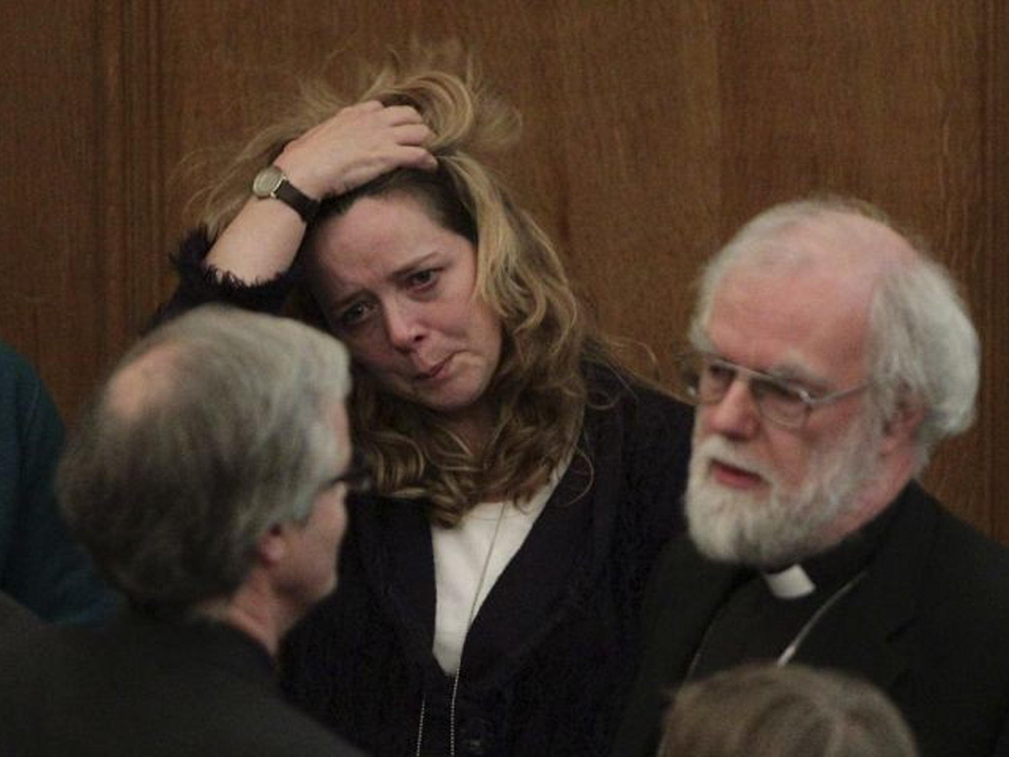 Canon Paula Gooder looks on alongside Rowan Williams, the outgoing Archbishop of Canterbury, after the decision is announced