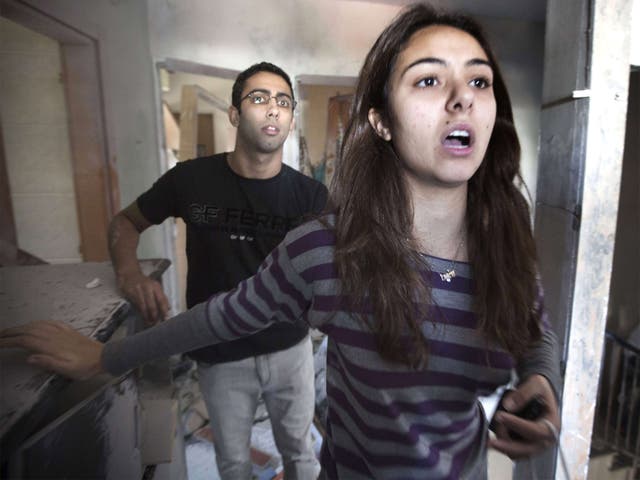Lotam Hakmon and her brother survey rocket damage to their homes in Beersheeba, Israel