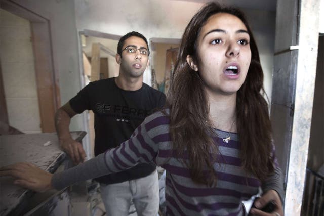 Lotam Hakmon and her brother survey rocket damage to their homes in Beersheeba, Israel