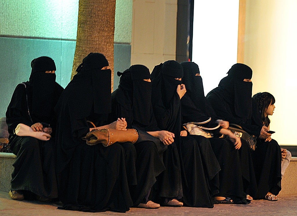 Saudi women wait for their drivers outside a shopping mall in Riyadh