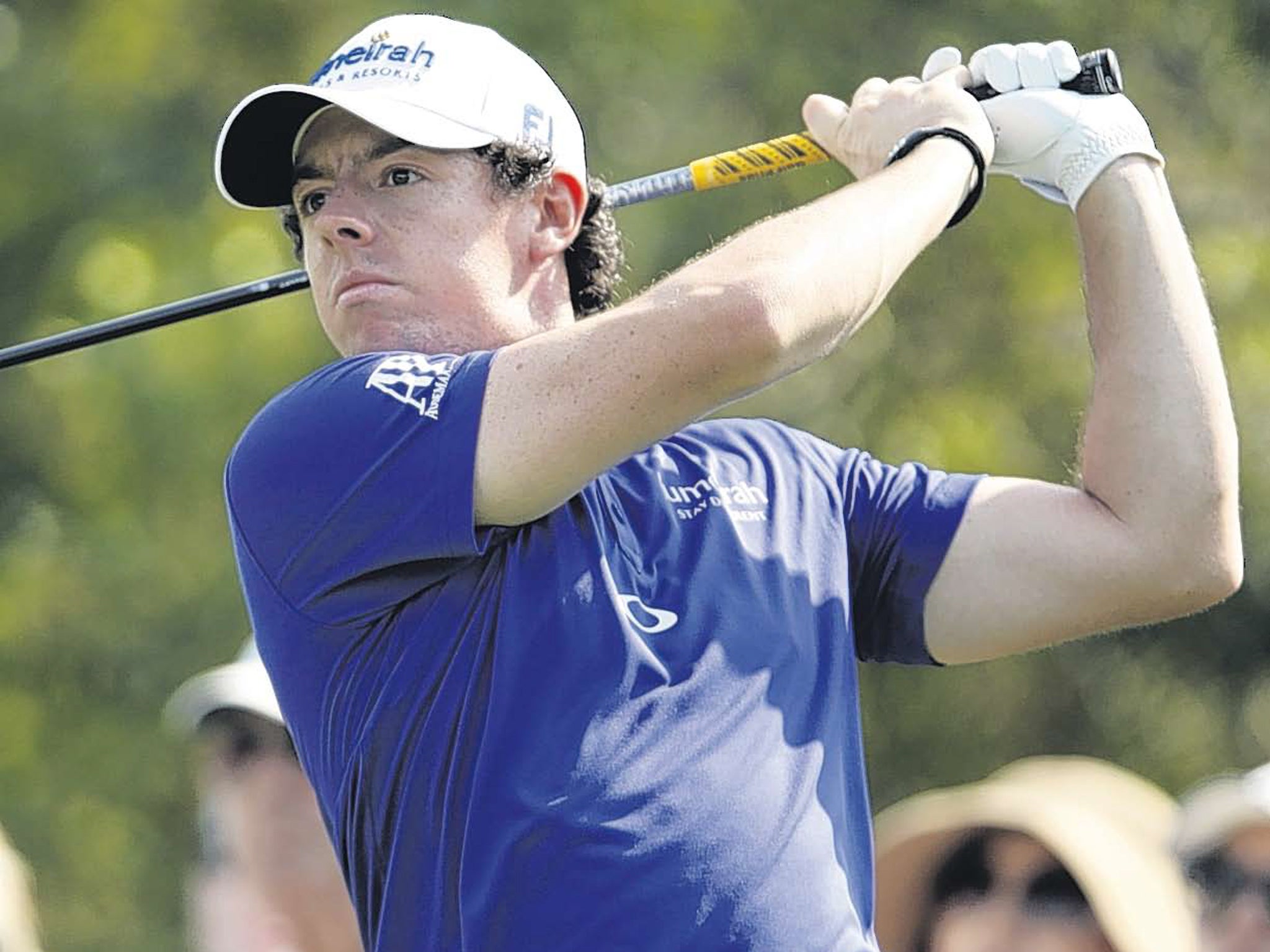 Rory McIlroy watches his tee shot on the third hole