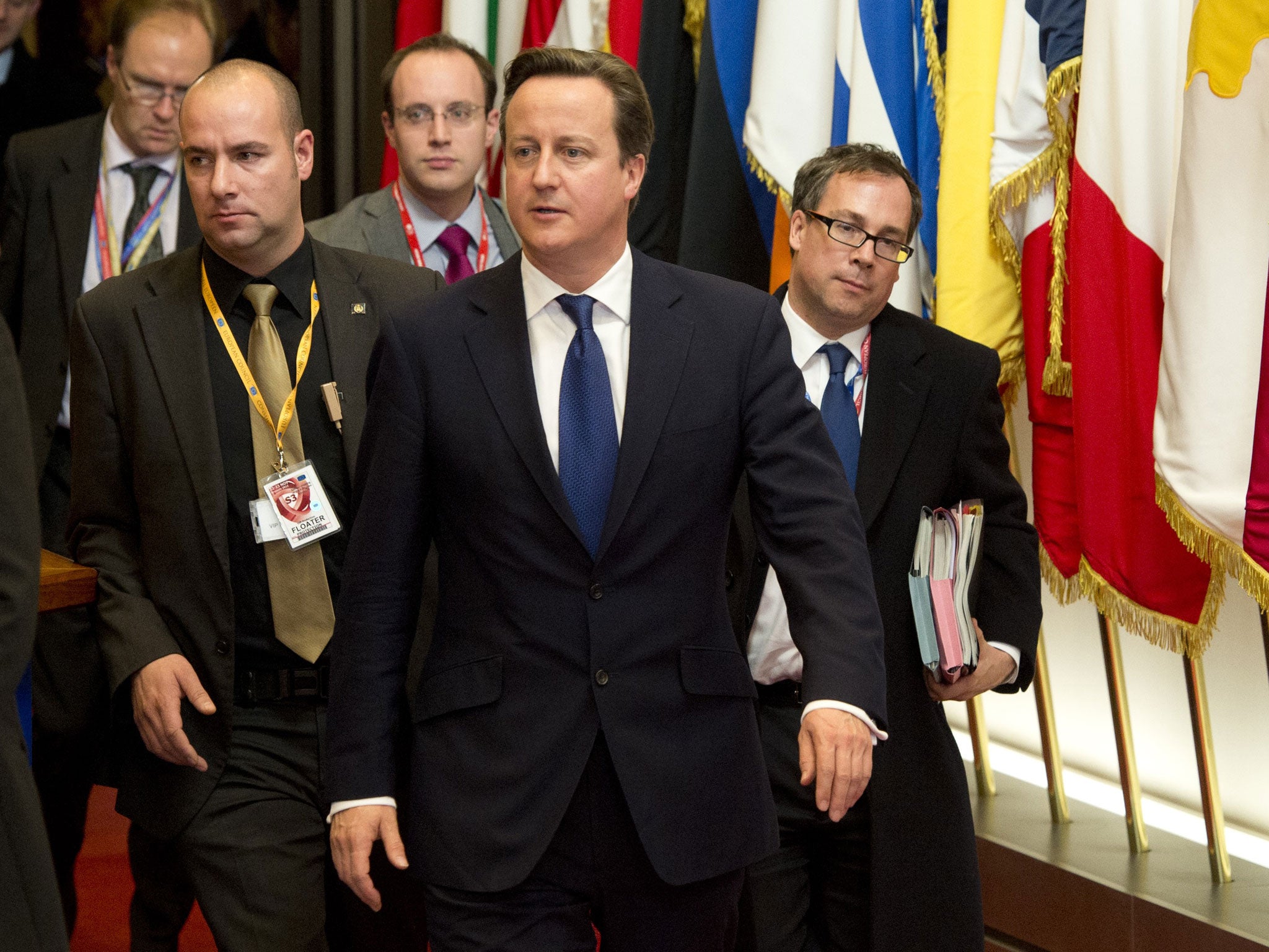 David Cameron, centre, departs after the EU summit in Brussels