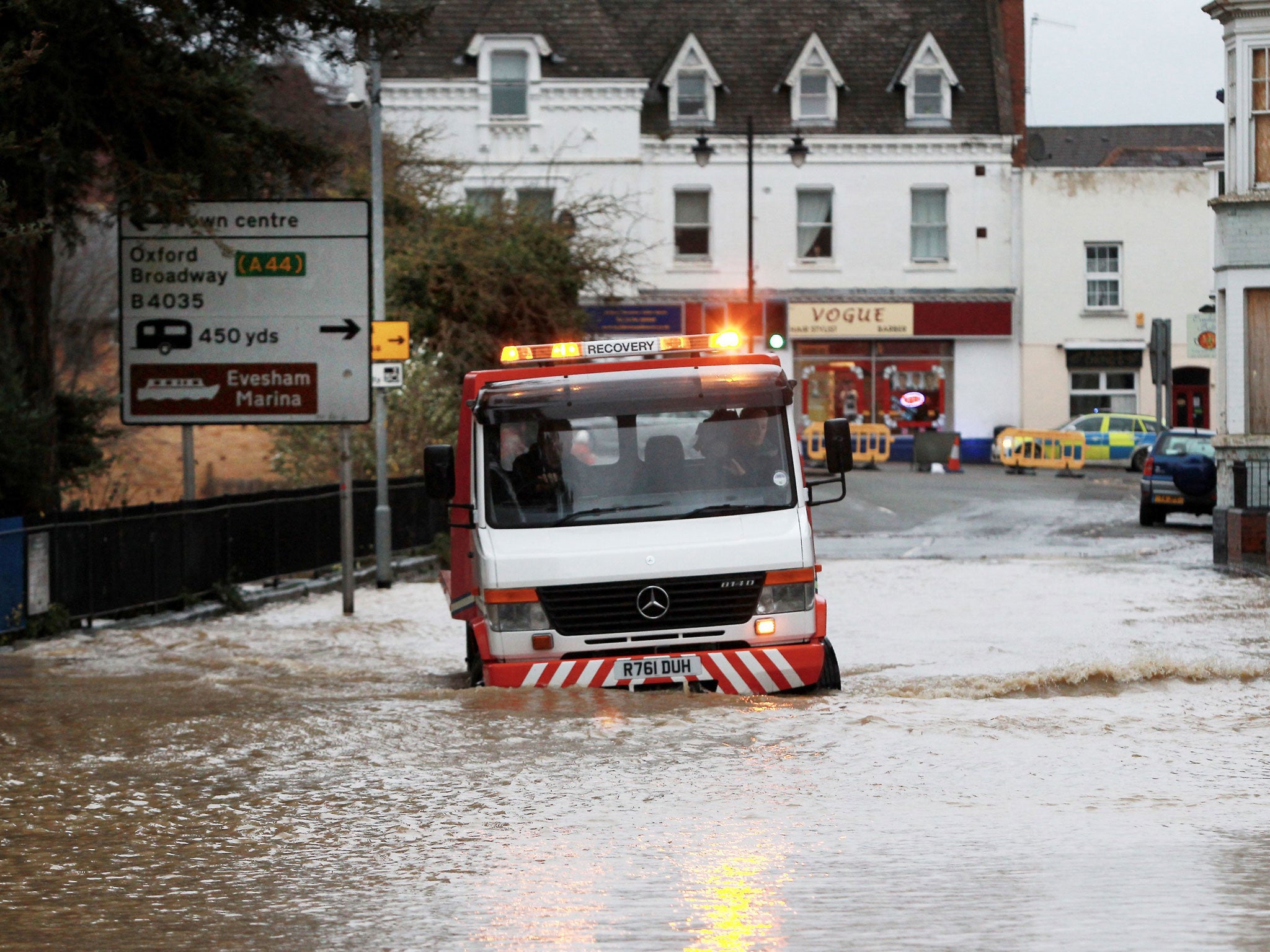 A recovery vehicle negotiates floodwaters in Evesham, Worcestershire