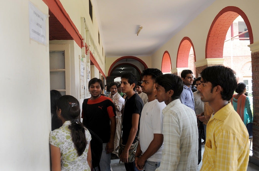 Indian students stand in a queue for admission forms at Delhi University in New Delhi