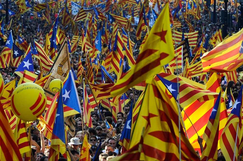 People hold Pro-independence Catalan flags in a demonstration calling for independence during the Catalonia's National Day on September 11, 2012