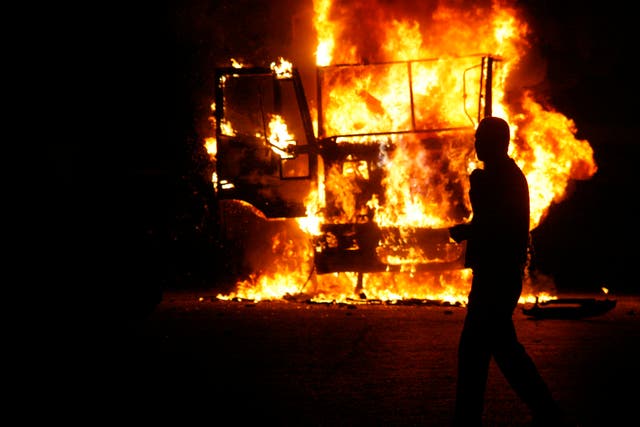 An Egyptian man walks by a burning Egyptian police truck during a demonstration against Egypt's Islamist President Mohamed Morsi on November 23, 2012 in Cairo. Morsi insisted that Egypt is on the path to 'freedom and democracy' after granting himself swee