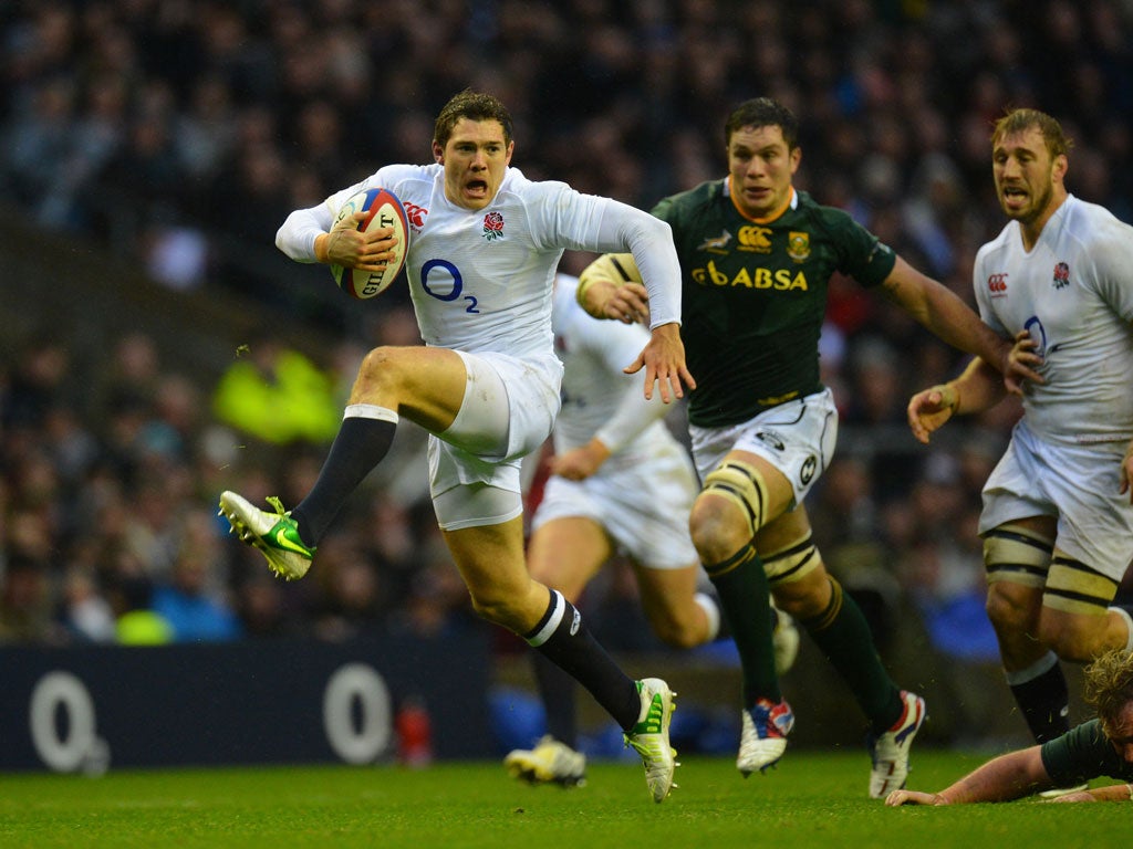 Alex Goode of England charges with the ball