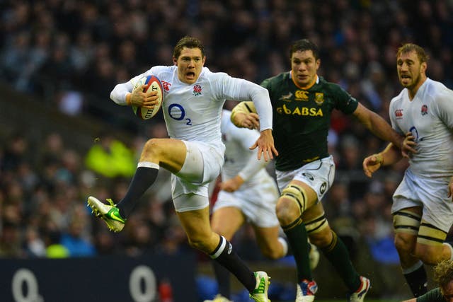 Alex Goode of England charges with the ball