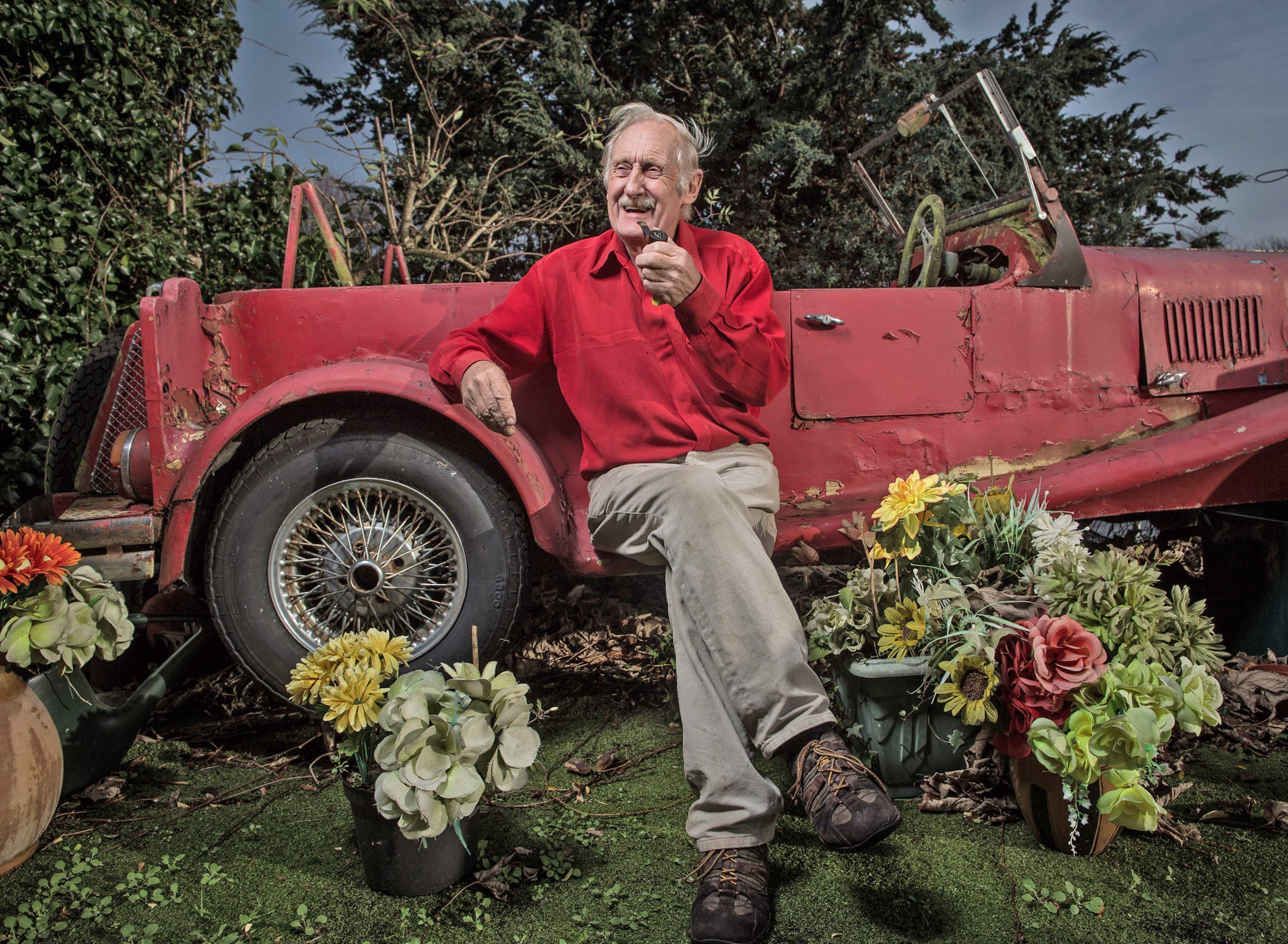Driven eccentric: Trevor Baylis sits in his garden with his self-modified Ford Cortina, which has about six inches on the clock