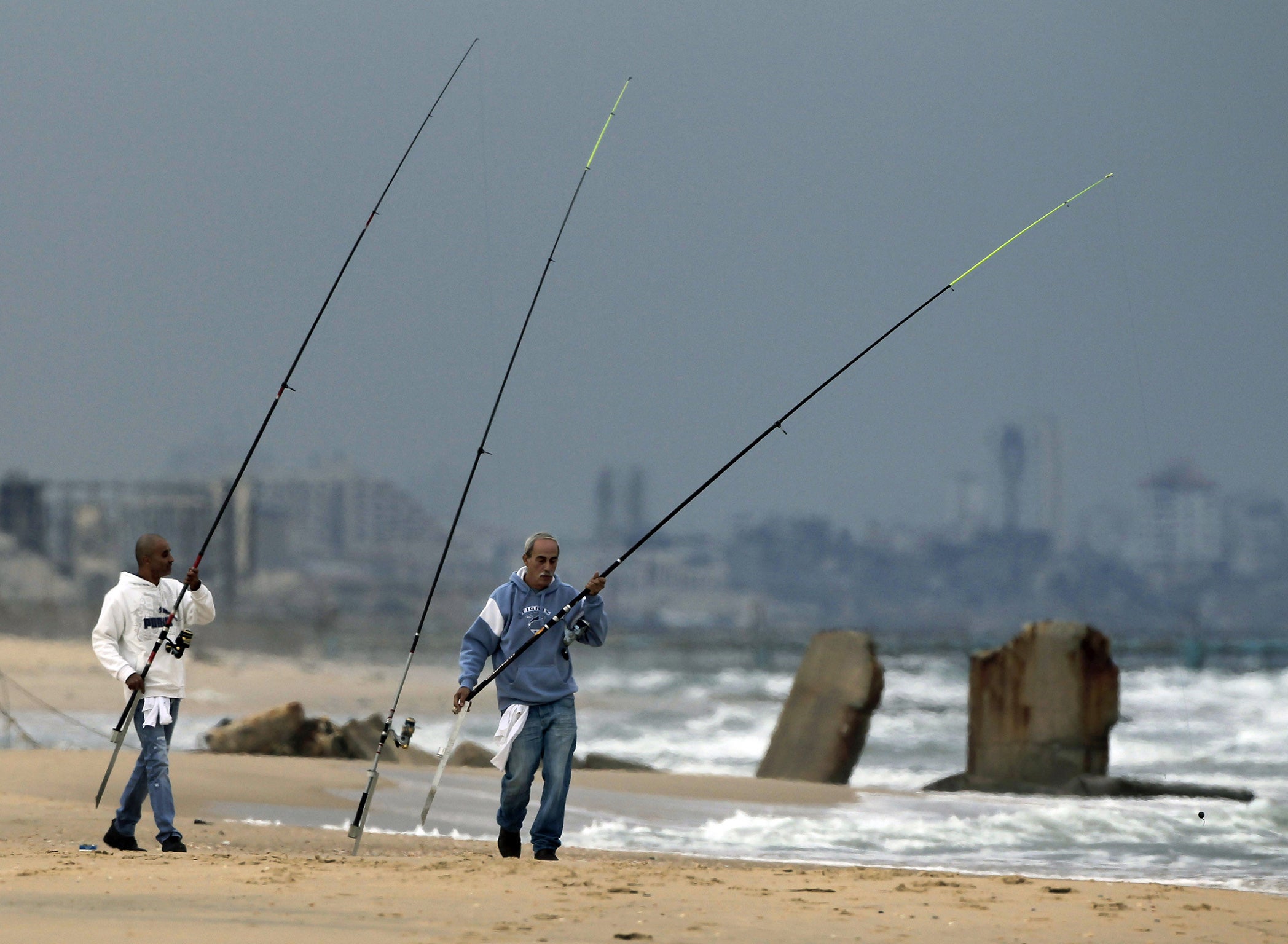 Clear skies: Israelis fish on a beach near the Israel-Gaza Strip border yesterday, as the truce holds