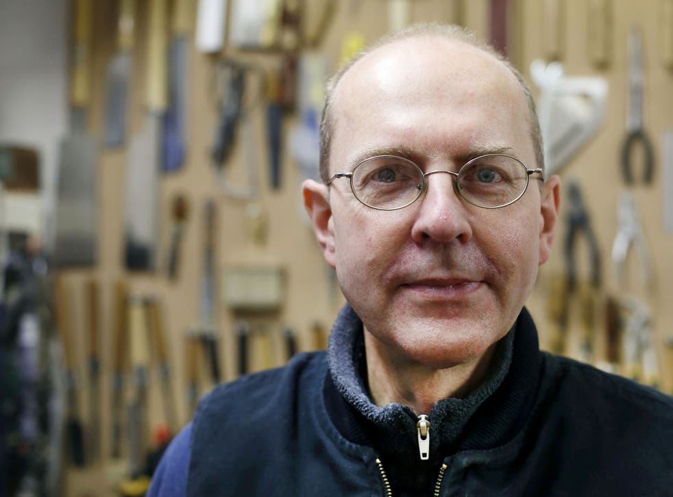 Canadian-born furniture-maker Michael Ibsen, a direct descendant of the eldest sister of medieval British King Richard III, poses in his furniture workshop in London. An archaeological thriller has ignited a passion for history in Britain, where ongoing D