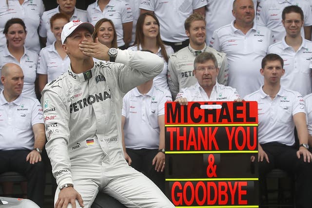 Mercedes Formula One driver Schumacher gestures during a photo call before the Brazilian F1 Grand Prix at Interlagos 