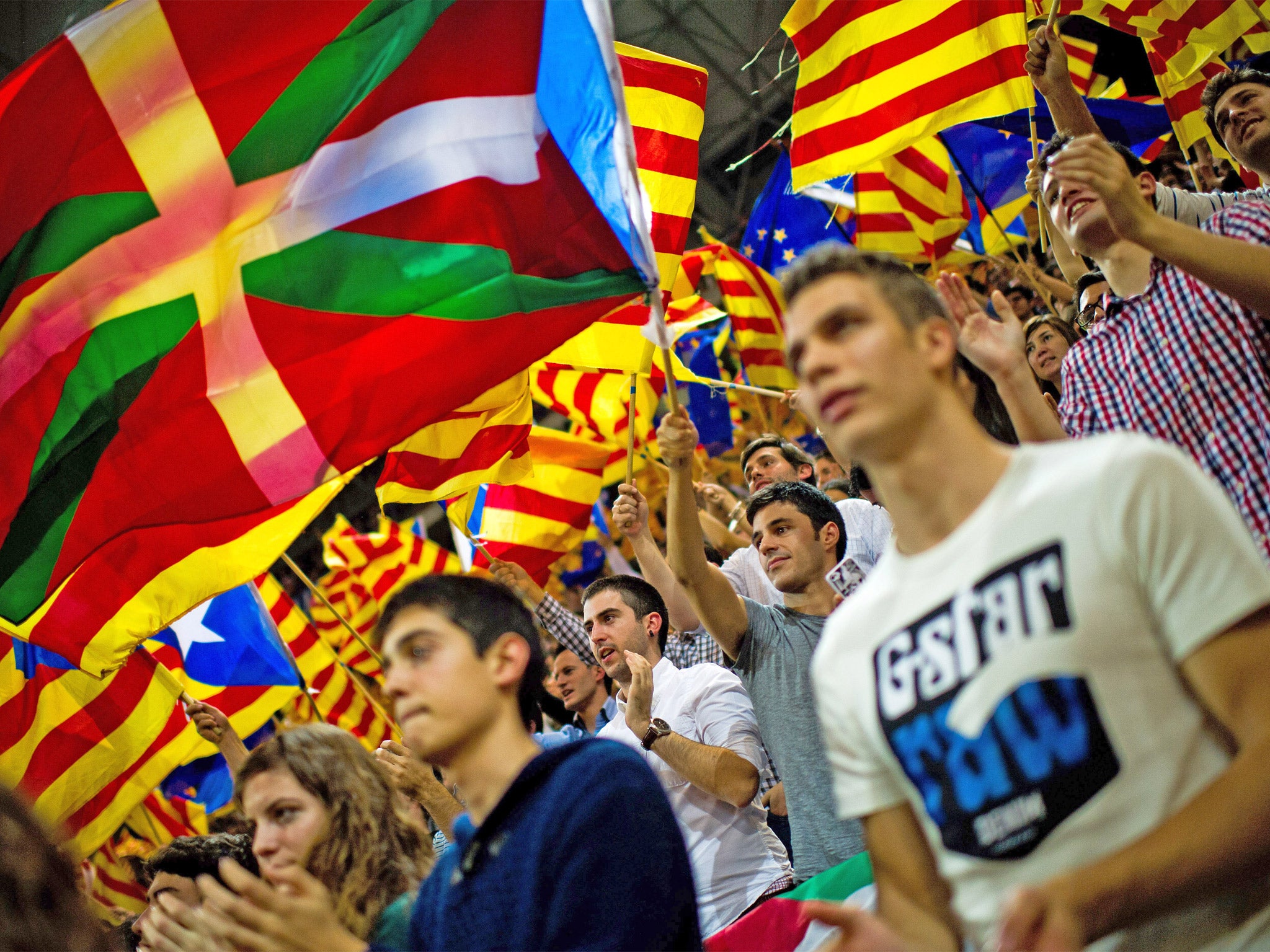Supporters of the Pro-independence Catalan party Convergence and Union (CIU) fly a Basque Country flag
