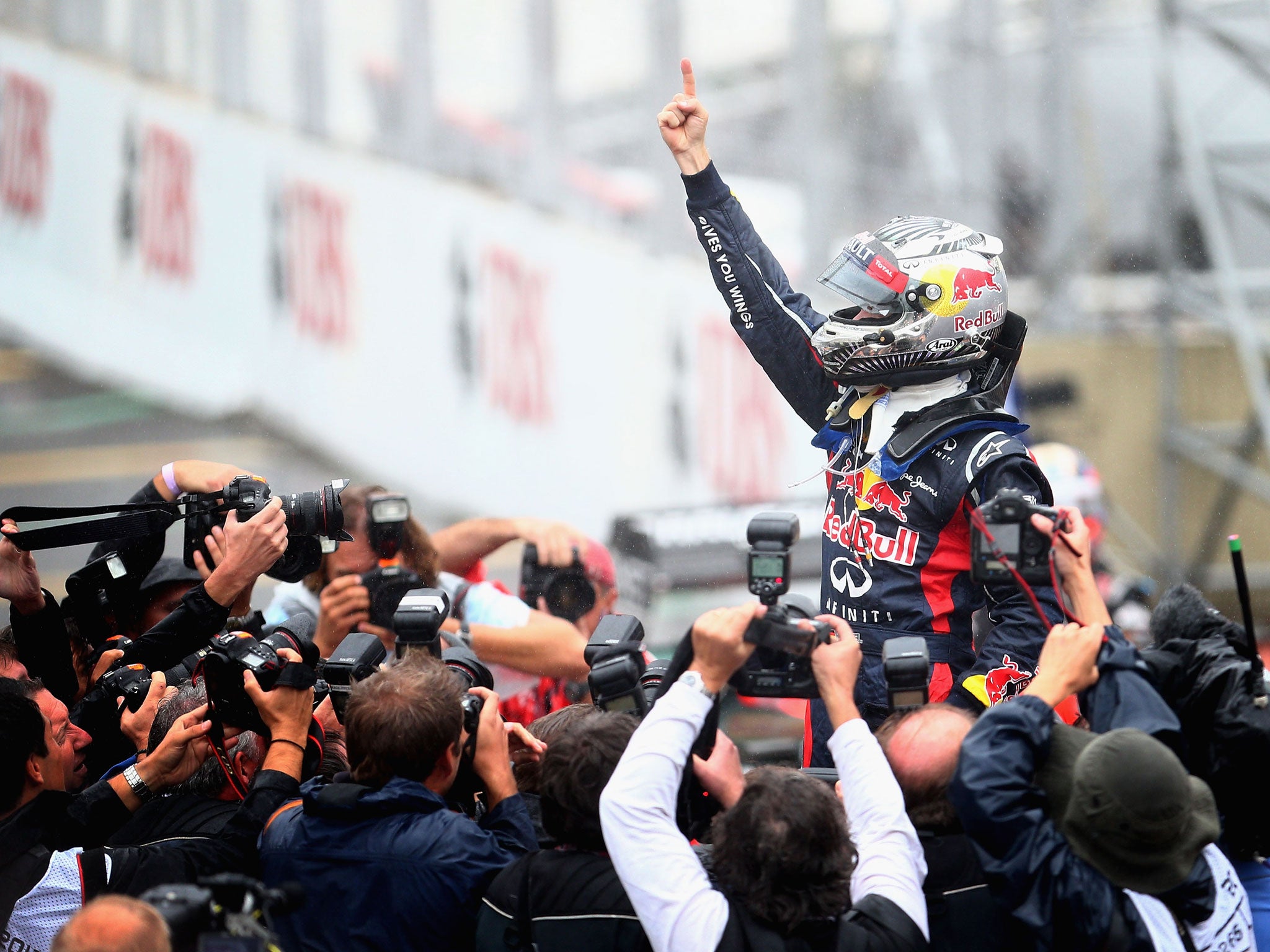 Sebastian Vettel of Germany and Red Bull Racing celebrates in parc ferme as he finishes in sixth position and clinches the drivers world championship during the Brazilian Formula One Grand Prix