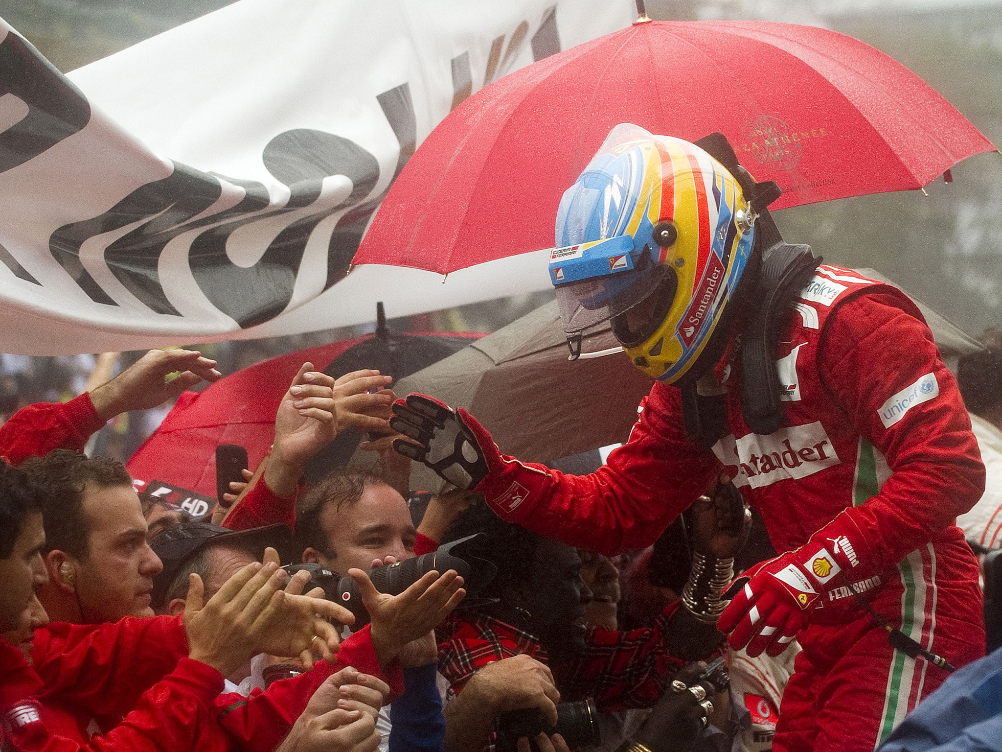 Spanish Formula One driver Fernando Alonso with the Ferrari team after missing out on another championship title in the last race of the season