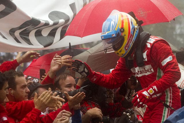 Spanish Formula One driver Fernando Alonso with the Ferrari team after missing out on another championship title in the last race of the season