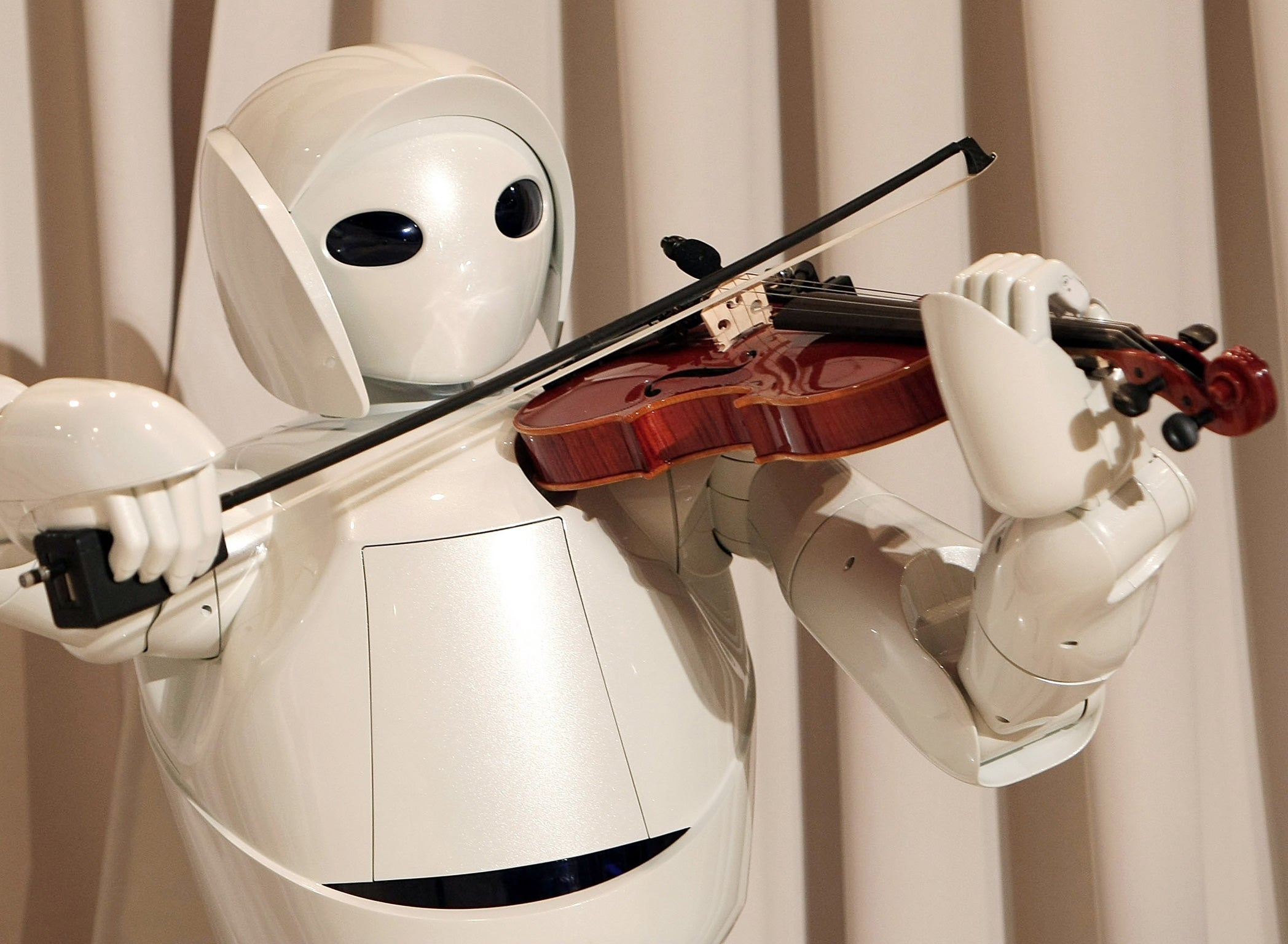 Toyota's violin-playing robot plays at Tokyo's Universal Design Showcase in 2007
