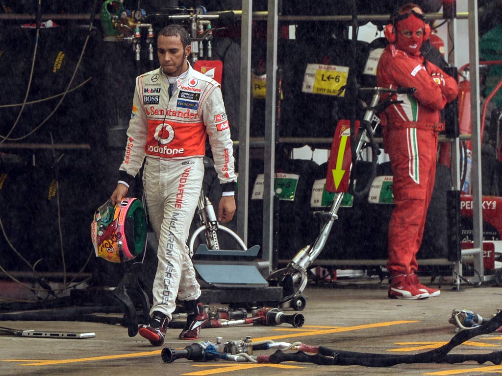 Lewis Hamilton walks in the pits of Interlagos race track