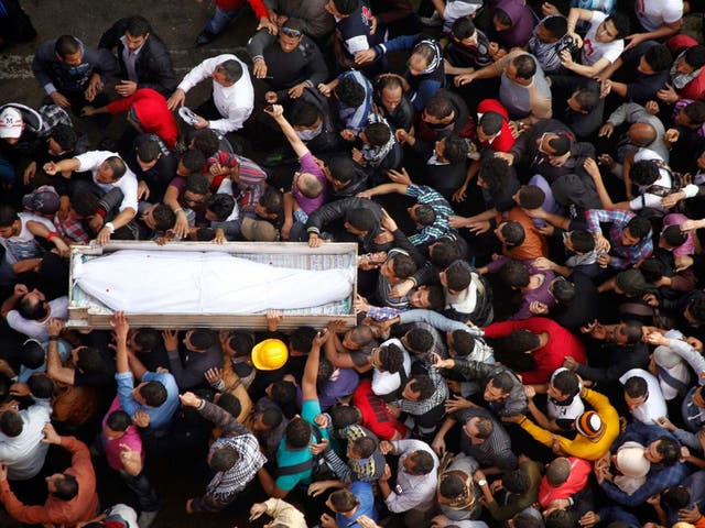 Mourners carry the coffin of Gaber Salah, an activist who died in clashes at Cairo’s Tahrir Square last week, at his funeral