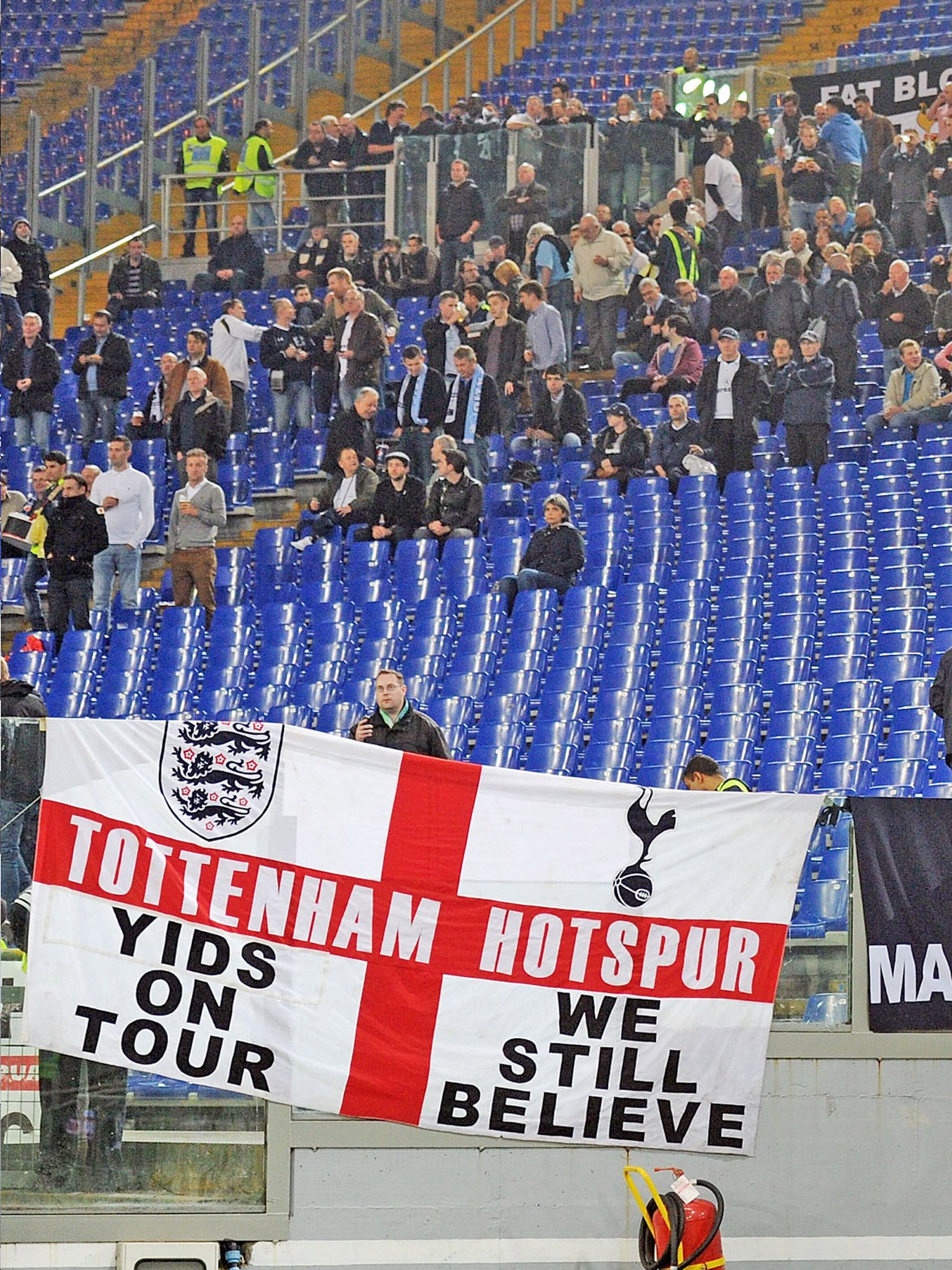 A section of Spurs fans rally behind a controversial banner