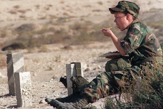 A female US soldier eats breakfast while on tour in Afghanistan