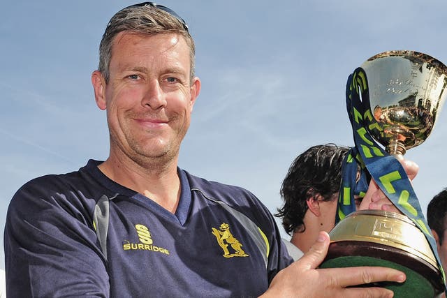 Ashley Giles holds aloft the County Championship trophy