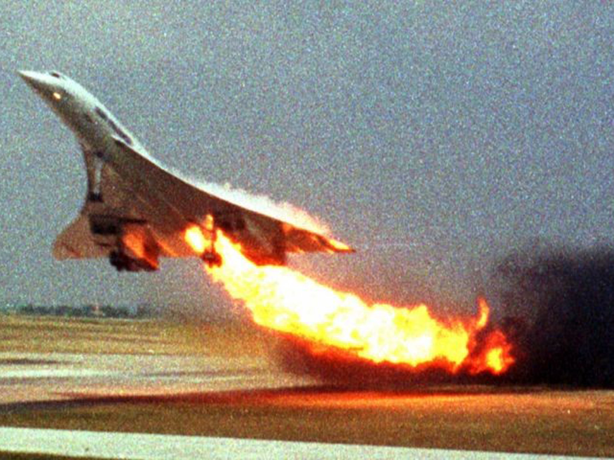 France Concorde flight 4590 takes off with fire trailing from its engine on the left wing from Charles de Gaulle airport in Paris