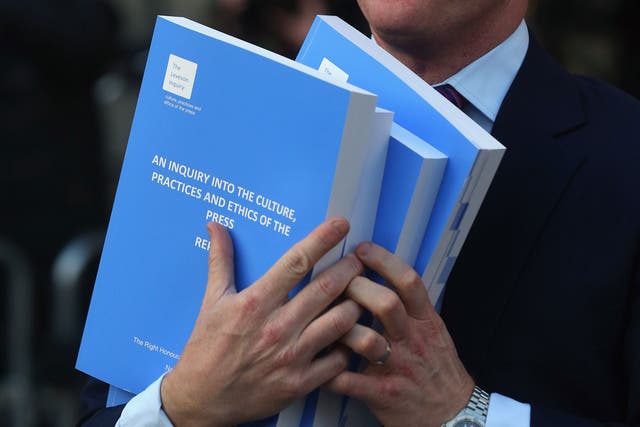 Labour MP Chris Bryant leaves the Queen Elizabeth II conference centre with a copies of the Leveson Inquiry on November 29, 2012 in London, England.