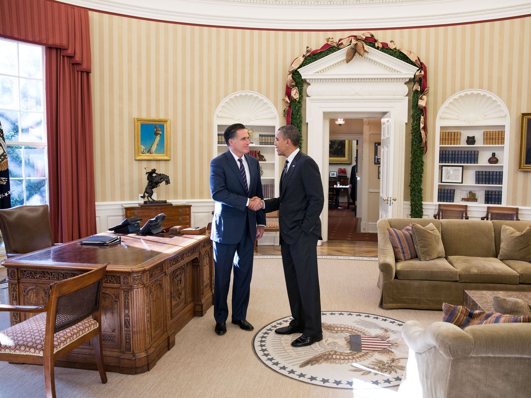 Former Massachusetts governor Mitt Romney shakes hands with President Barack Obama in the Oval Office before lunch Thursday at the White House. The White House reported that Romney congratulated Obama on his victory and wished him well.
