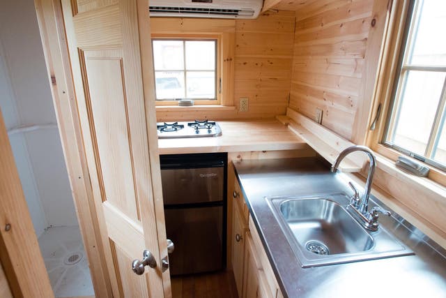 TINYHOUSES: The bathroom sits next to the kitchen in this tiny house; despite their diminutive spaces, the houses have fully functioning kitchens and bathrooms.