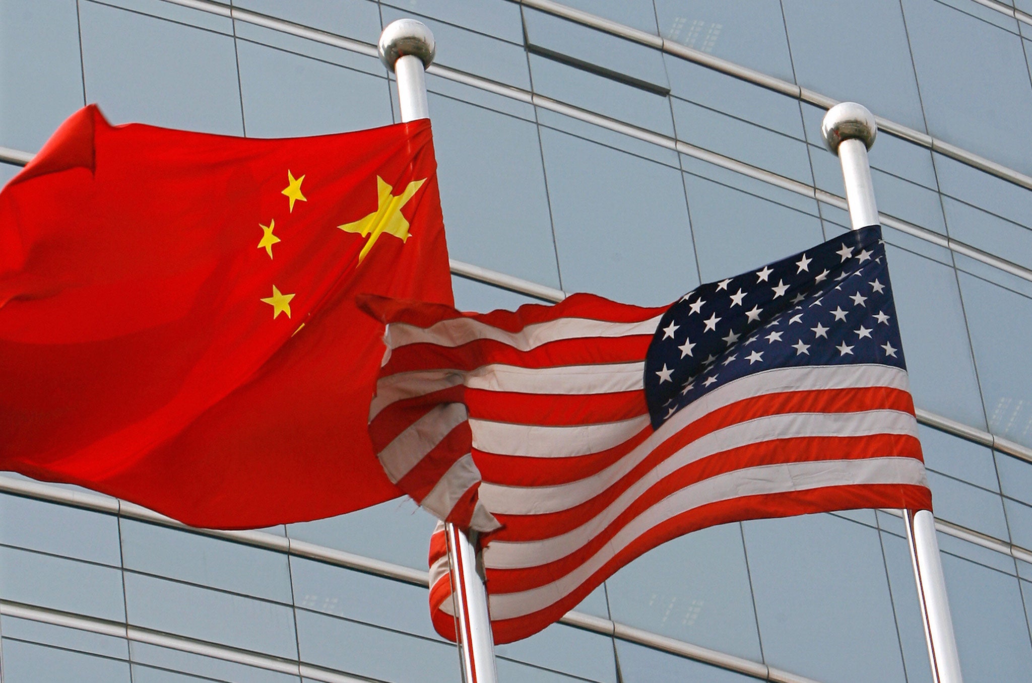 A US and a Chinese flag wave outside a commercial building in Beijing, 09 July 2007.