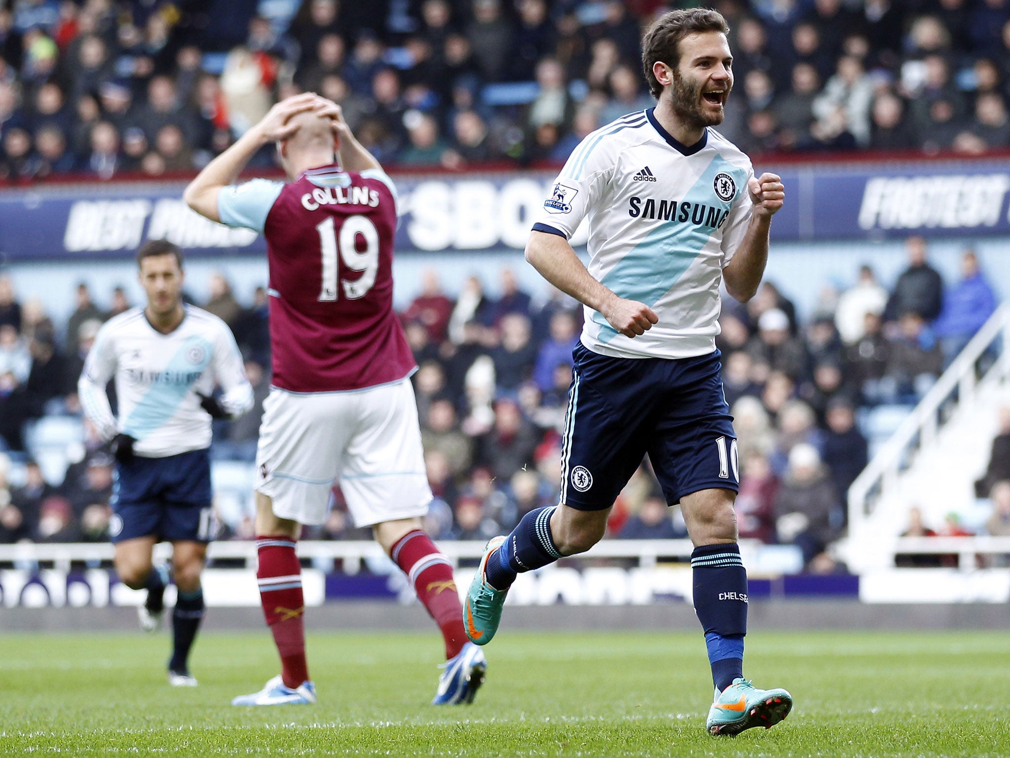 Juan Mata of Chelsea celebrates his goal, much to James Collins of West Ham's despair