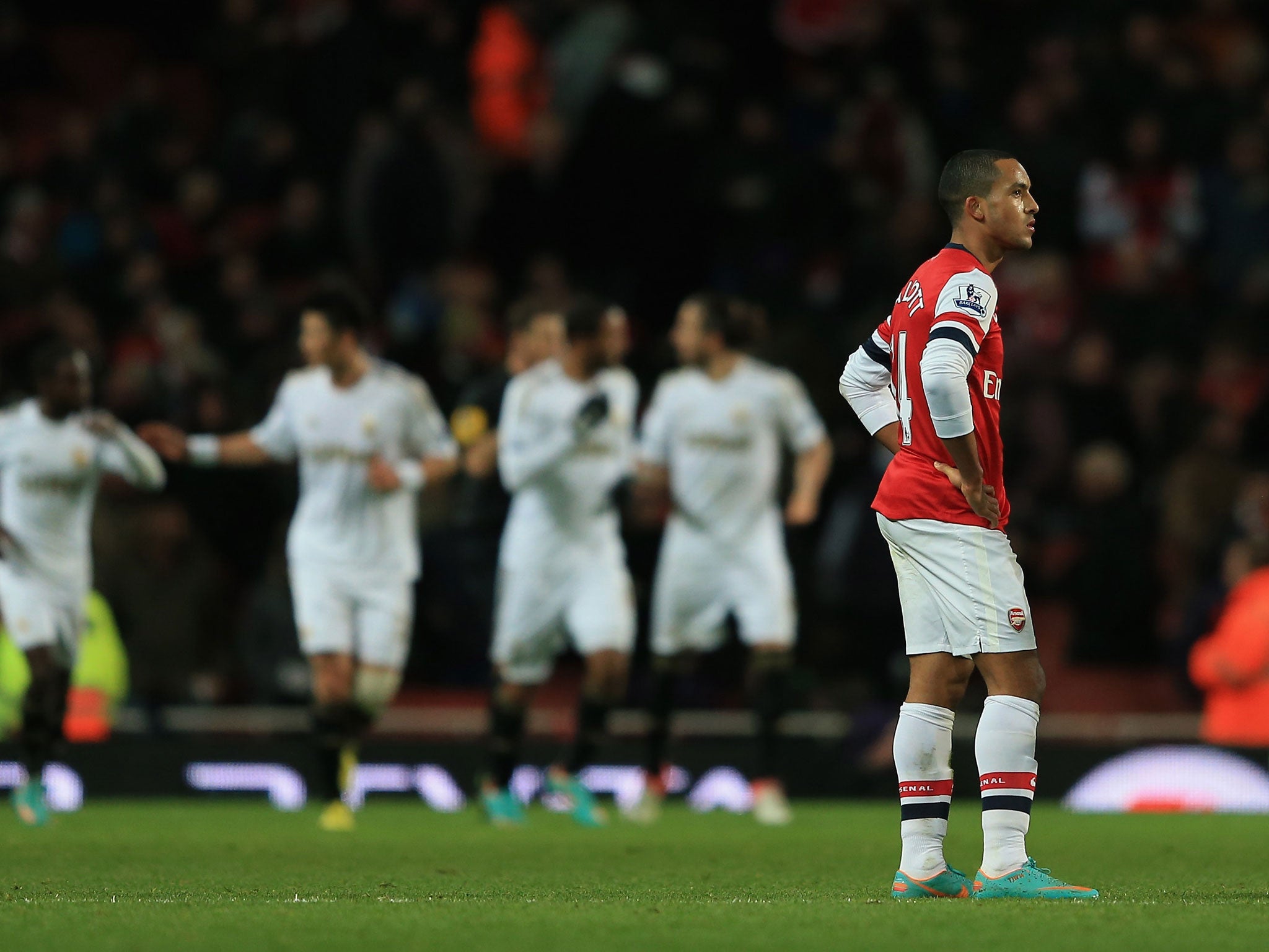 Theo Walcott looks upset after Swansea score their opening goal late in the second half