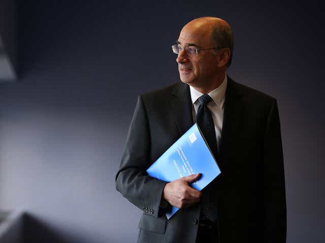 Lord Leveson poses with a summary report into press standards