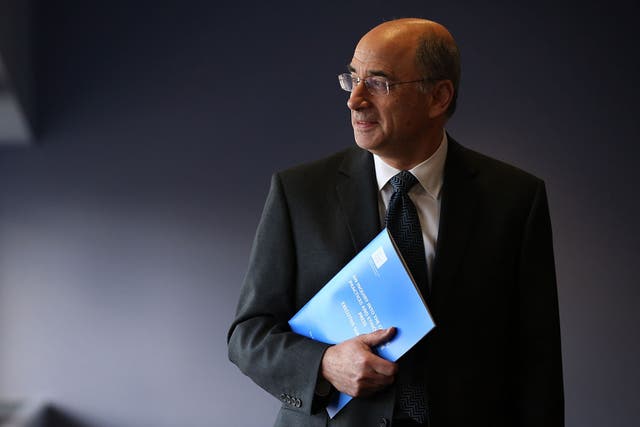 Lord Leveson poses with a summary report into press standards