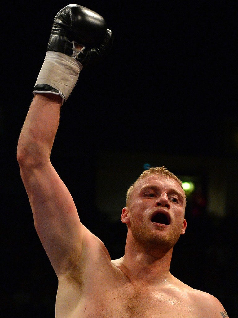 Glove puppet: Former cricketer Freddie Flintoff celebrates his win in a fight which many observers have condemned as nothing more than a stunt