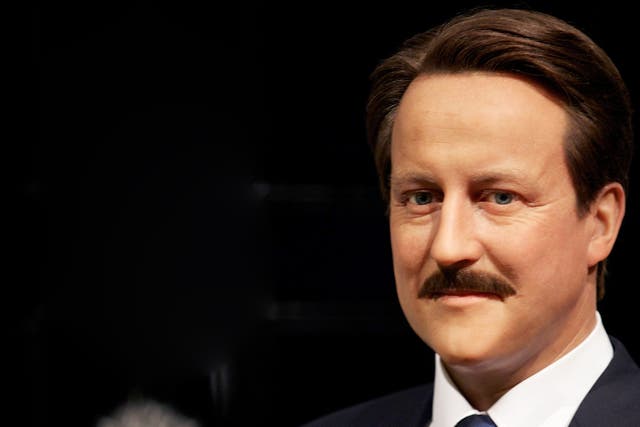 A wax figure of British Prime Minister David Cameron with a moustache is displayed at Madame Tussauds.
