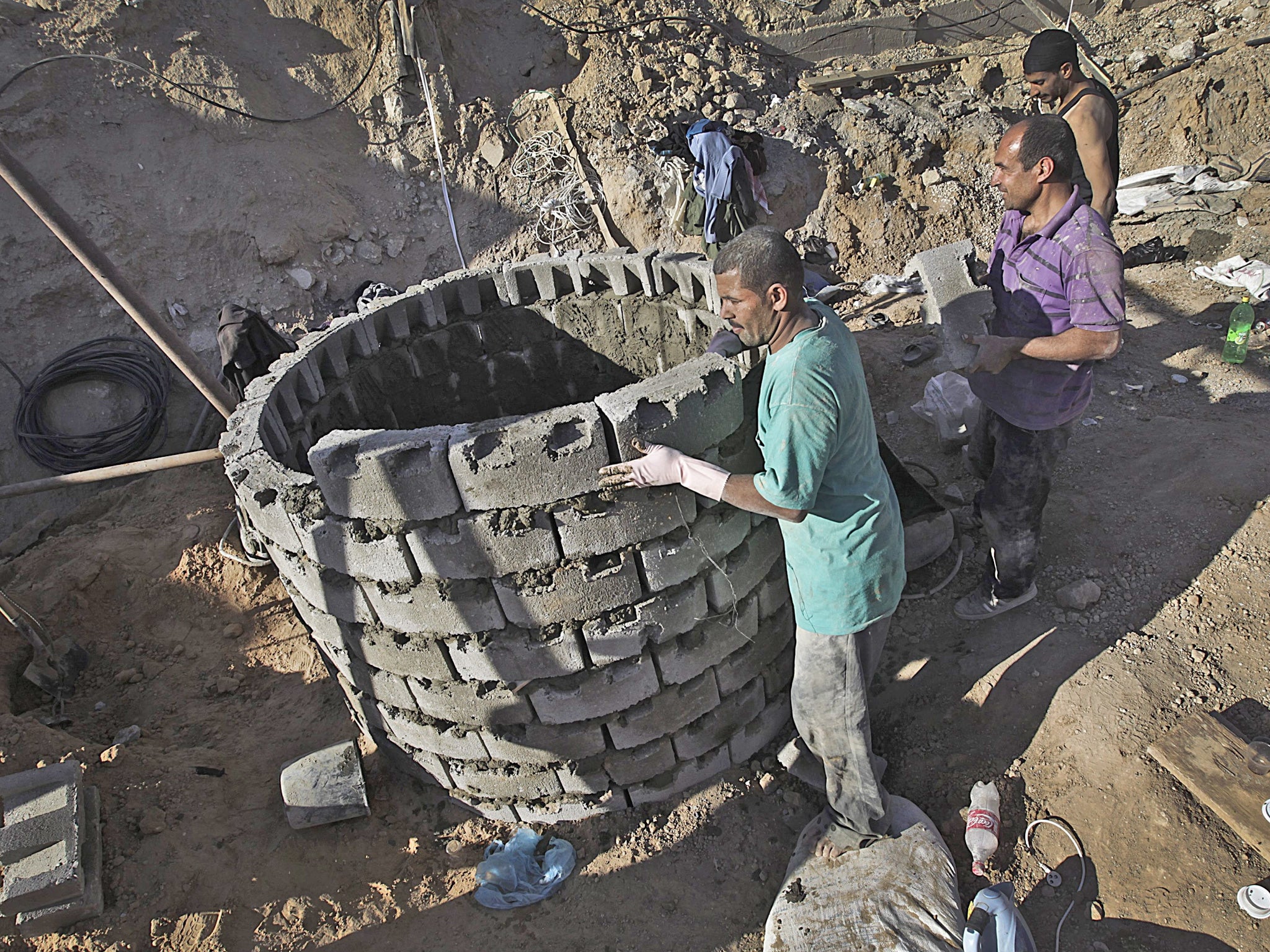 Labourers repair a bombed tunnel in Rafah on Sunday