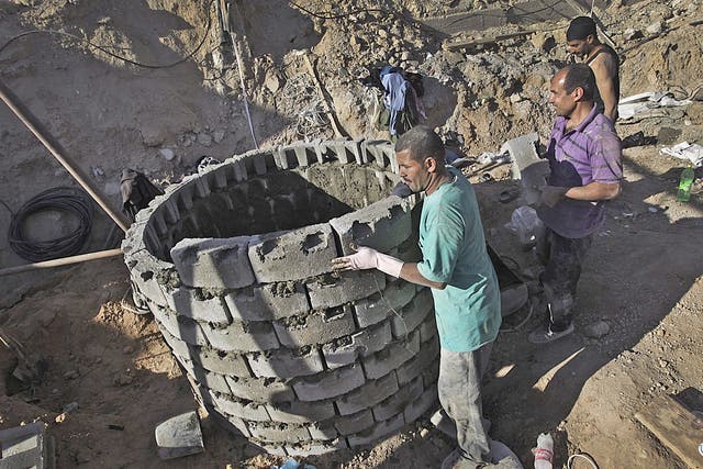 Labourers repair a bombed tunnel in Rafah on Sunday