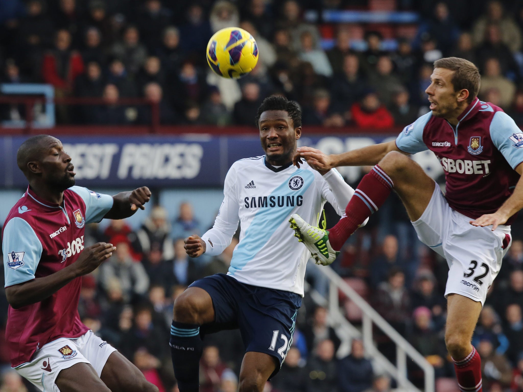 John Obi Mikel of Chelsea (C) vies for the ball with Gary O'Neil (R) and Carlton Cole (L) of West Ham United