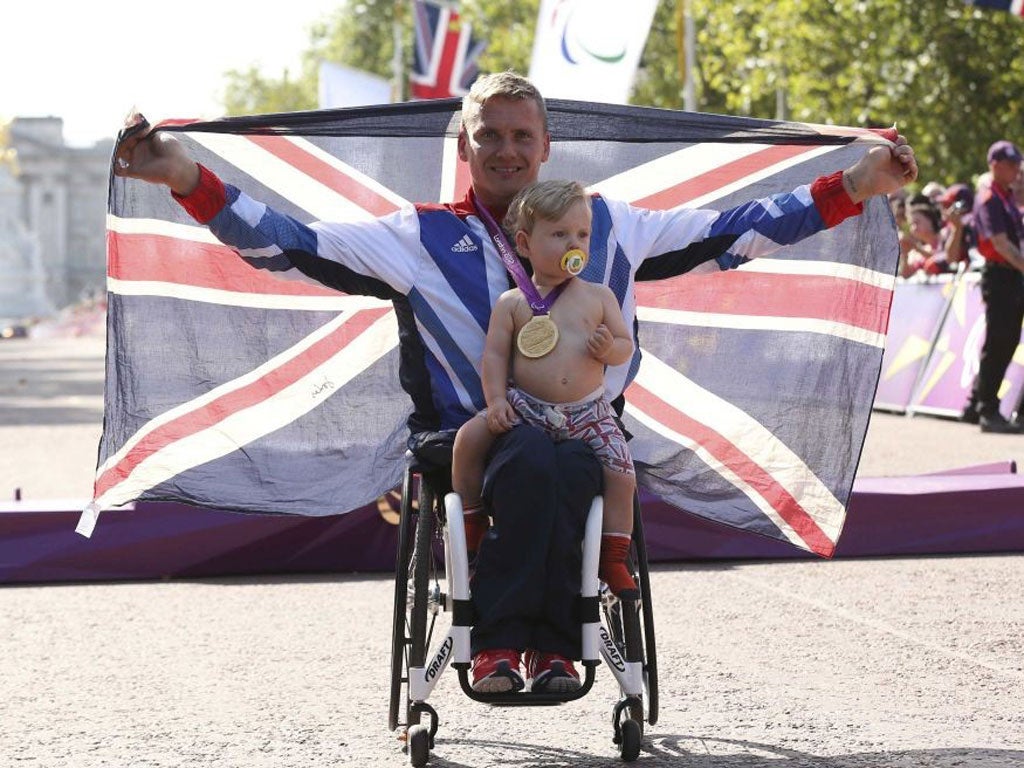 David Weir celebrates with his son Mason after winning the men’s
marathon T54 yesterday