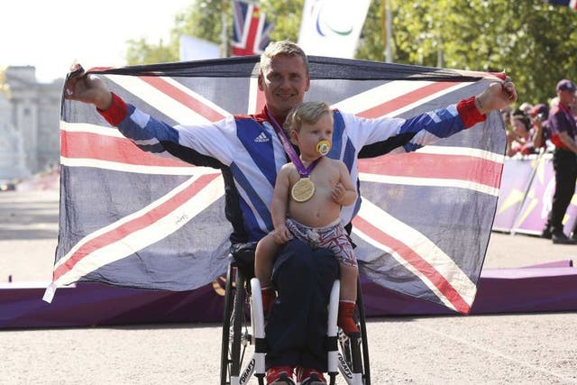 David Weir celebrates with his son Mason after winning the men’s
marathon T54 yesterday