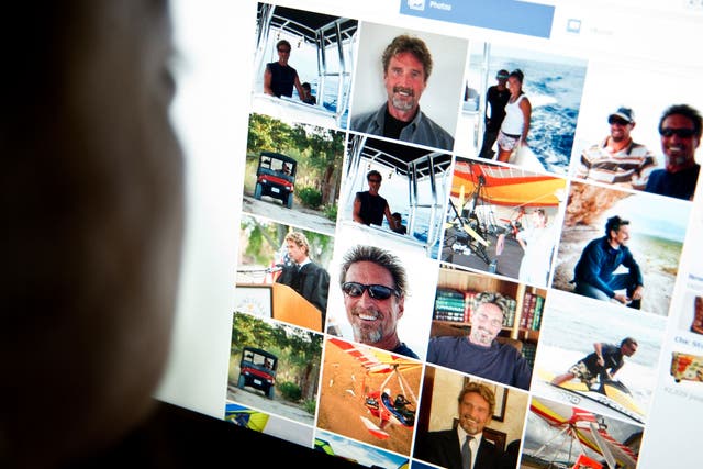 This photo taken November 13, 2012 in Washington, DC shows a woman viewing a facebook page belonging to John McAfee(pictured).
