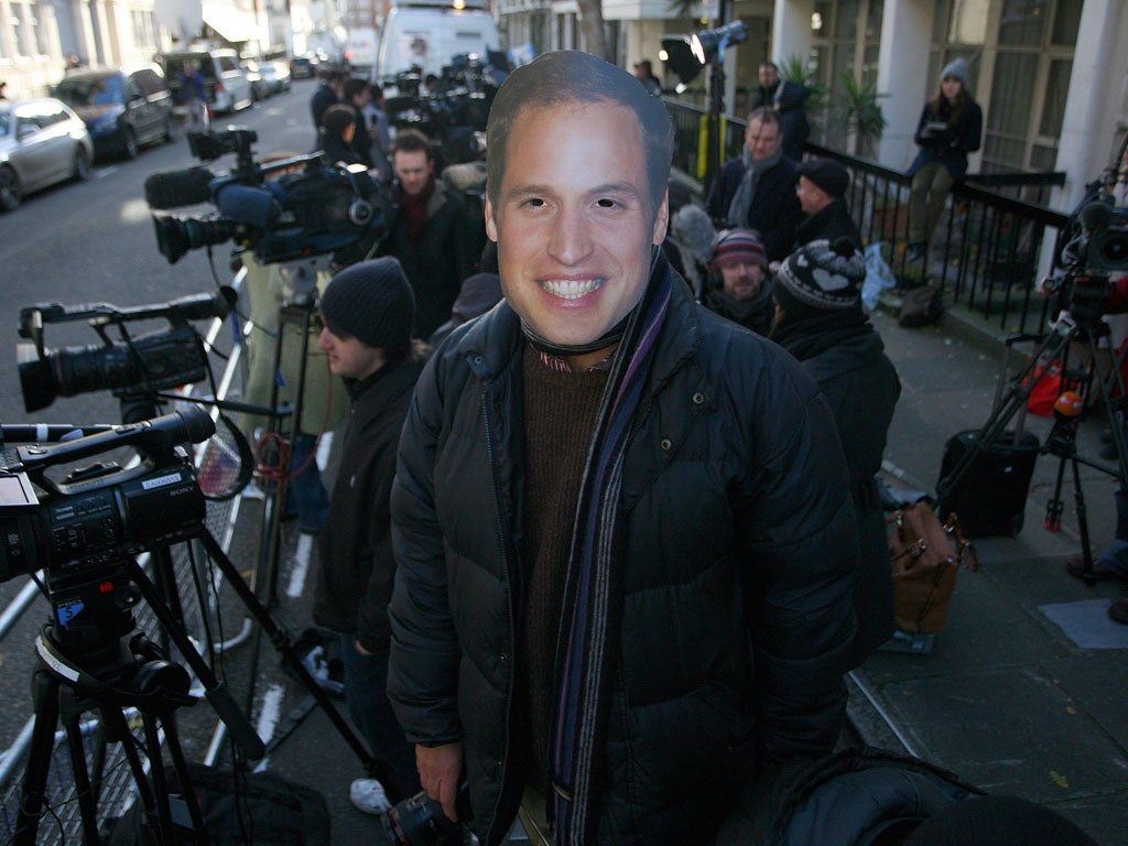A Prince William mask pictured on a photographer in the media pen outside King Edward VII's Hospital in London