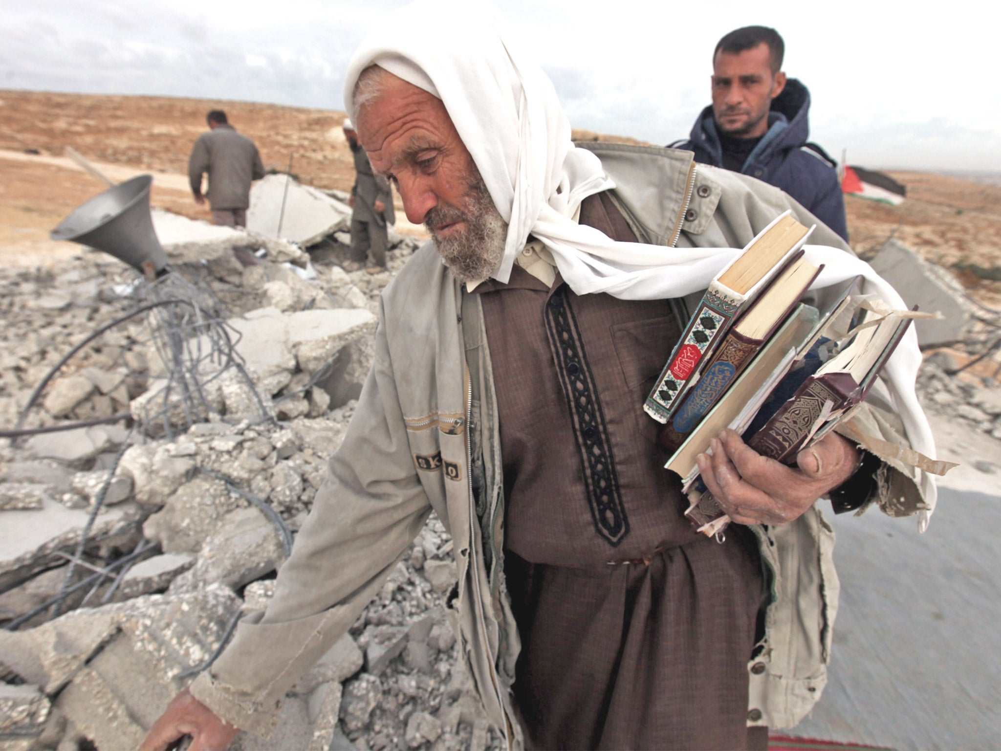 Palestinians at the rubble of a mosque near Hebron after it was destroyed by the Israeli army