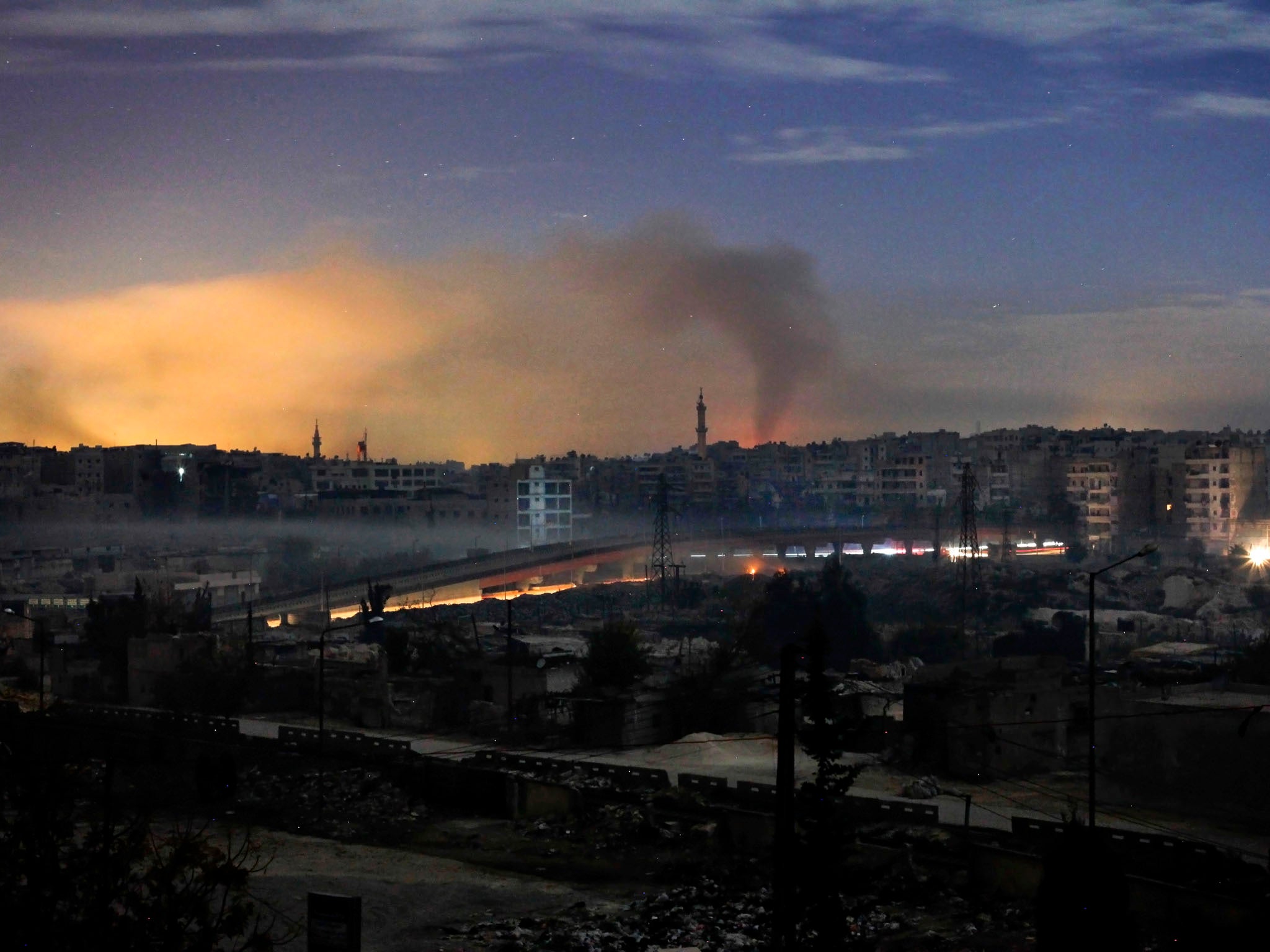 Smoke rises in the Hanano and Bustan al-Basha districts in the northern city of Aleppo on December 1, 2012 as fighting continues through the night. A large rebel force launched an offensive on one of the few army bases in northwestern Syria still in the h